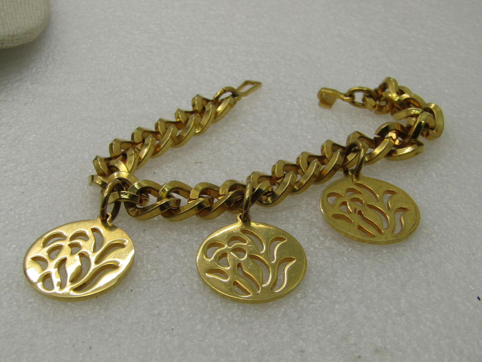Vintage Cut-Out Iris Floral Charm Bracelet, 7.5", 1970's: Vintage Cut-Out Iris Floral Charm Bracelet, 7.5", 1970's, 95mm chunky curb link chain with a unique toggle clasp. It is more like a hook that slides through an elongaged link. Three iris charms that a