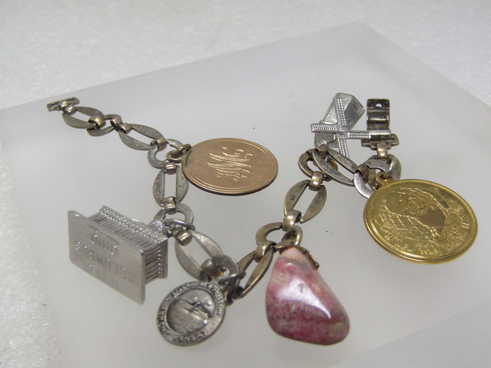 Vintage Sterling Charm Bracelet, 7.75: 6 Charms, 1960's, Some Signed: Vintage Sterling Charm Bracelet, 7.75: 6 Charms, 1960's, Some Signed. This hasa gold filled charm with initial AMC . There is a sterling Capitol Building , Columbus, Ohio, signed Wells; Sterling Eisen