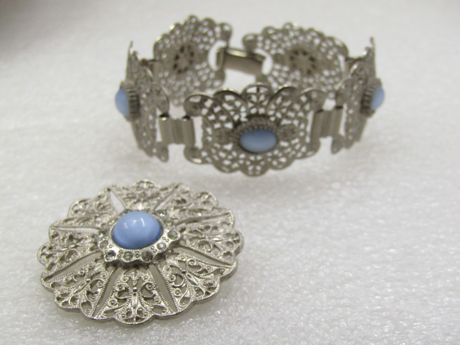 Vintage Filigree Blue Moonstone Bracelet & Brooch, 7", Silver Tone, Mid-Century: Vintage Filigree Blue Moonstone Bracelet & Brooch, 7", Silver Tone, Mid-Century, 7" bracelet and '1.5" brooch, sligtly domed with scalloped edge on bracelet and brooch. The bracelet is appx. 1" wide.