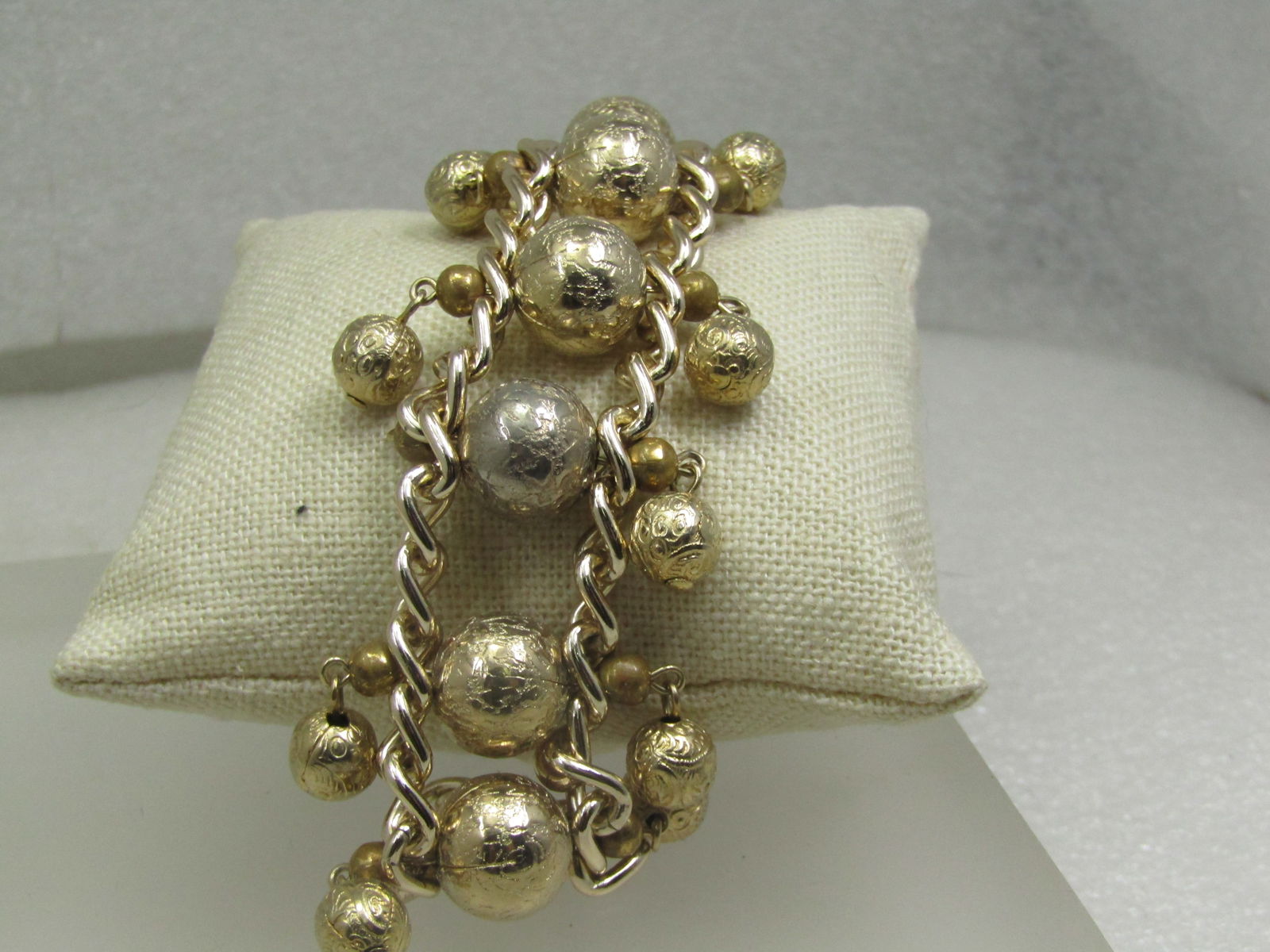 Vintage Beaded & Dangle Wide Bracelet, 7.5", Gold Tone: Vintage Beaded & Dangle Wide Bracelet, 7.5", Gold Tone. The center beads are appx. 12.5mm wide and the dangle beads are appx. 7.5mm and also are textured. Unfortunate one bead is missing on the edge w