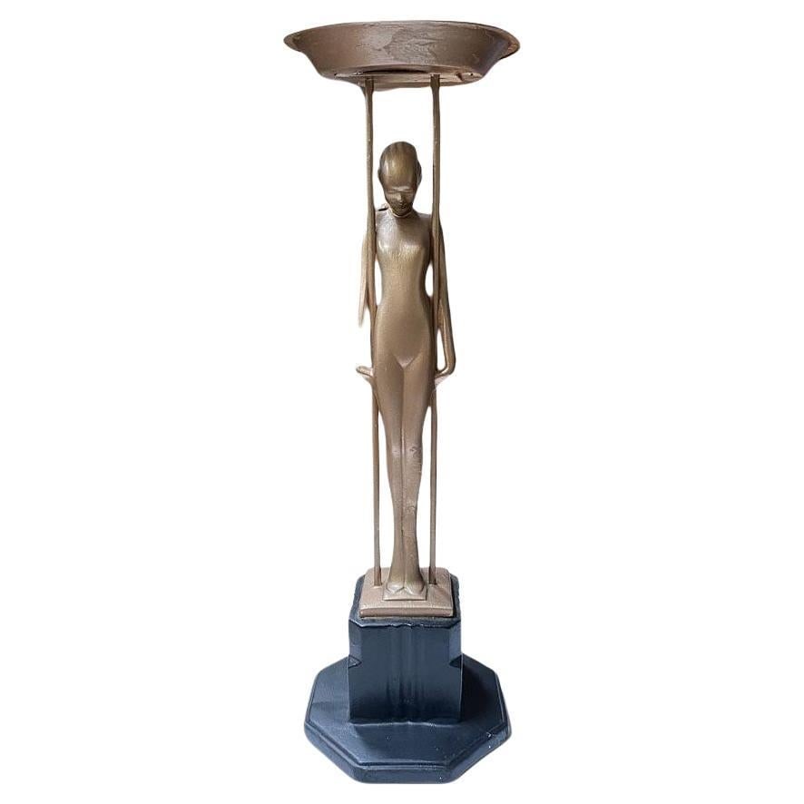 Frankart Copper-Tone Nude “Sarcophagus Girl“ Figural Cocktail Smoker: Frankart company figural “Sarcophagus Girl“ metal ashtray stand featuring a nude women holding up the ashtray stand standing on a stepped art deco base. Frankart # T349, patent # 85411 by