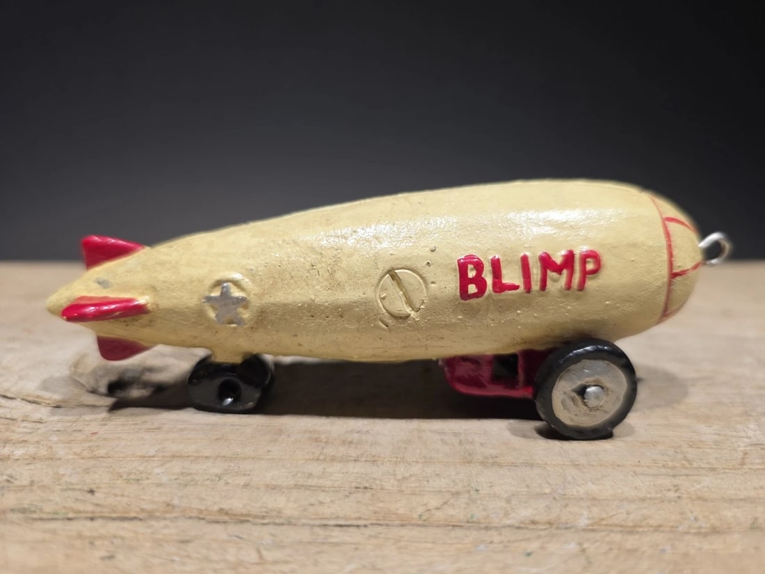 Antique Vintage Style Cast Iron Mini Cast Iron Blimp Zeppelin Pull Toy: 5 Long 1 3/4 Tall Great little reproduction cast iron pull toy. All cast iron hand painted, slightly distress as shown in the images. Certainly looks old! Limited availability! 100% Customer Satisfact
