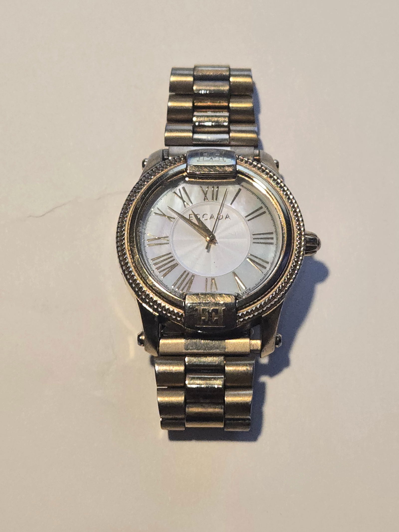 Escada Silver/Gold Tone"Madelene" Watch: Title:Escada Silver/Gold Tone"Madelene" Watch Metal Purity (If Applicable):Stainless Steel Gemstones: Carat Weights:82.53g Size/Dimensions:2" diameter Additional Info:Swiss Made Reserve: $125.00 Shipp