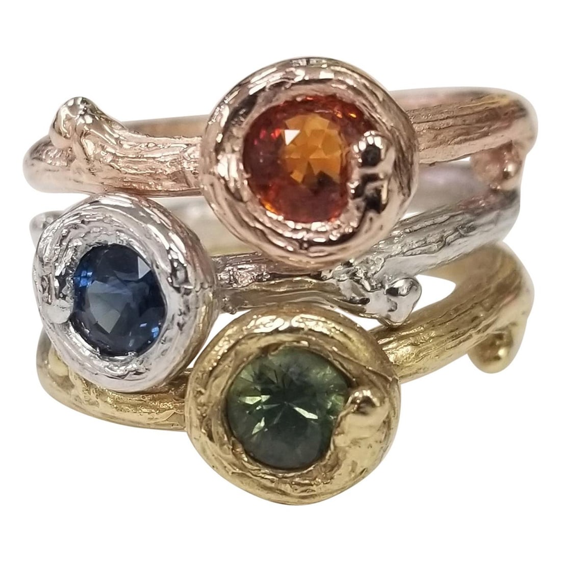 Set of 3 14k gold Multicolored Sapphire Bark Stack-Able Rings: Title: Set of 3 14k gold Multicolored Sapphire Bark Stack-Able Rings Description: 14k white, rose or yellow gold Gresha signature bark ring with 5mm Green, Blue and Orange sapphire weighing .50pts. ea