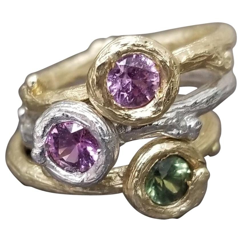 Set of 3 14k gold Multicolored Sapphire Bark Stack-able Rings: Title: Set of 3 14k gold Multicolored Sapphire Bark Stack-able Rings Description: 14k white and yellow gold Gresha signature bark ring with 5mm green, light pink and pink sapphire weighing .50pts. eac