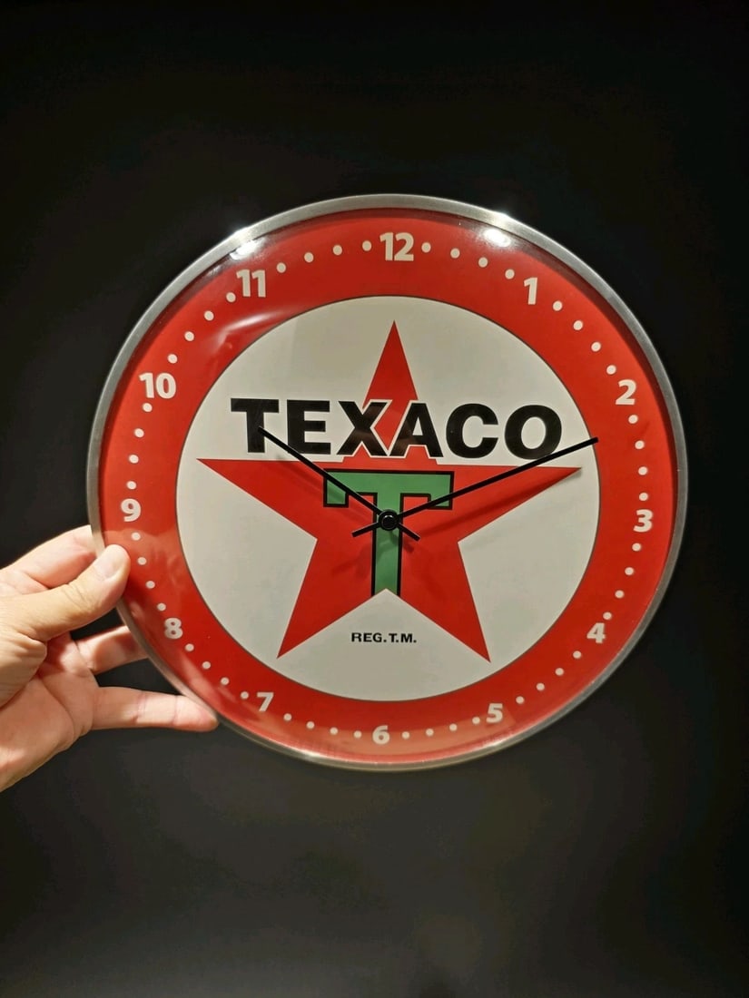 12" Round Texaco Gasoline Oil Wall Clock Sign: 12 Wonderful reproduction vintage-style Texaco Gas and Oil round clock. The clock face features the Texaco logo prominently in the center, with the word Texaco.. The clock's design is reminiscent of c
