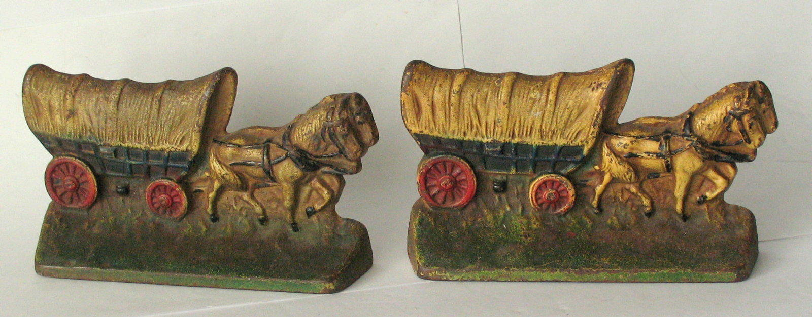 Antique cast iron Conestoga Wagon bookends.: Title: Antique cast iron Conestoga Wagon bookends. Date/Period: 1930's Dimension: 6” x 3 1/2” Additional Information: Nice pair of antique cast iron Conestoga Wagon bookends in original pa