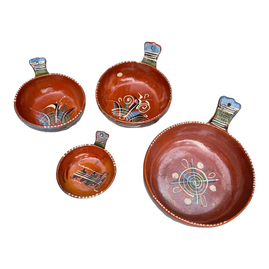 Tlaquepaque Mexican Pottery Redware Clay Handled Serving Nesting Bowls Set of 4: 1940's Mexican Bandera Glazed Redware Bowl Set of 4. These bowls nest. Bottoms are stamped 'Hecho en Mexico' (Made in Mexico) Hand-painted and glazed with different Mexican motif on the center of each