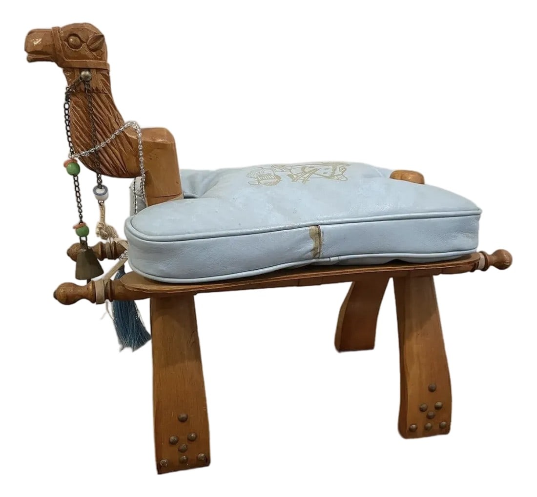 Mid 20th Century Vintage Turkish Camel Saddle Footstool in Light Blue Leather: This Mid 20th Century Vintage Turkish Camel Saddle Stool in Light Blue Leather provides an eclectic touch to any interior. Condition: Alterations: Original Condition Unaltered Imperfections: Some Impe