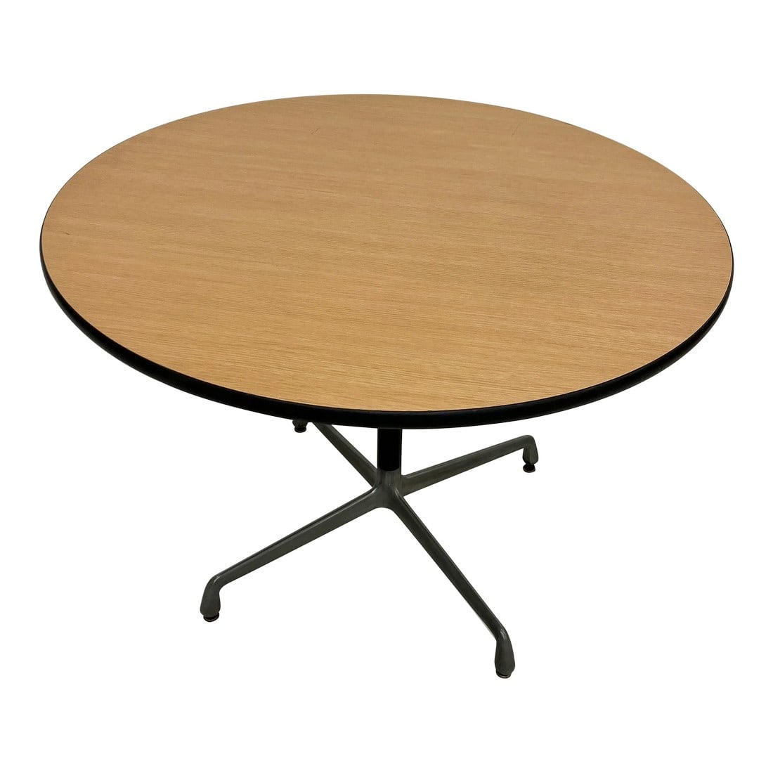 1980s Charles & Ray Eames Table by Herman Miller Aluminum Group: For your consideration, a Herman Miller Table Round table by Herman Miller Eames Aluminum Group HMA. Circa the 1980s USA. Maker label present. Aluminum and steel four-star base - tabletop wood grain a