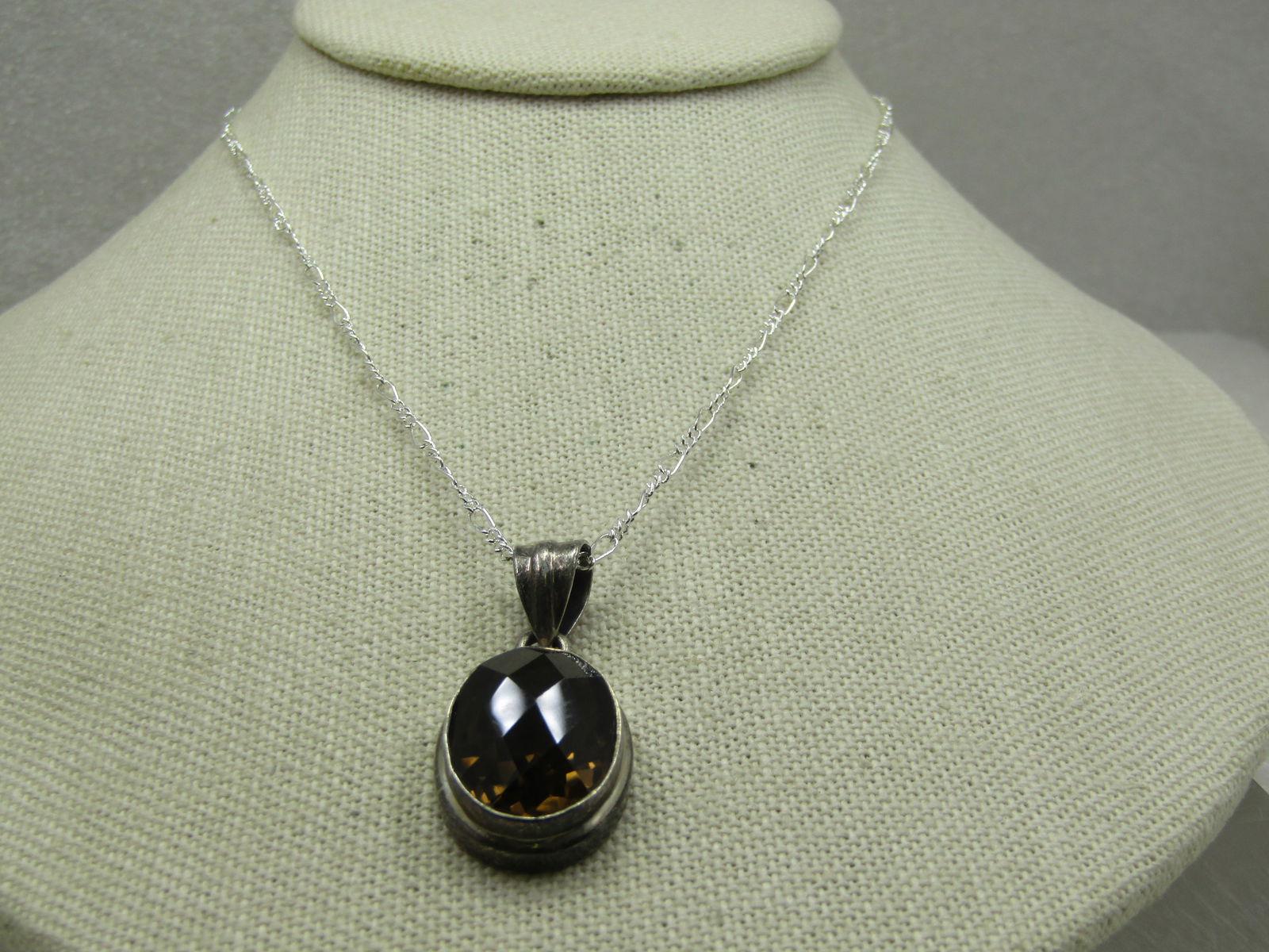 Vintage Sterling Smoky Topaz Necklace, 20" Figaro Chain: Title: Vintage Sterling Smoky Topaz Necklace, 20" Figaro Chain Description: Vintage Sterling Smoky Topaz Necklace, 20" Figaro Chain. The pendant has a wide ridged swith bail with an opening of 8.5mm b