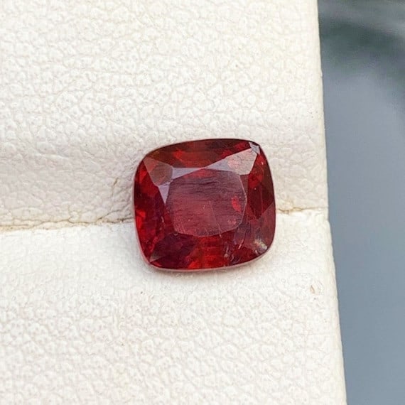 Deep Red Spinel Loose Gemstone, Ruby Red Spinel Gemstone For Ring Making: Details SKU 20 Dimensions (mm) 7 x 7 x 5 mm Weight (cts) 1.8 Treatment No Treatment Shape Cushion Type Faceted Clarity SI Colours Descript