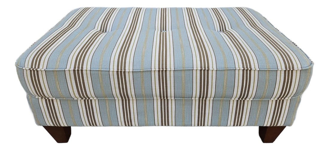 Blue and Brown Pillow Top Tufted Cocktail Ottoman Footstool: This large light blue ottoman is tufted and has a firm pillow top. The blue fabric is accented by brown and golden stripes and the piece sits atop mahogany-colored feet. This piece is by La-Z-Boy and