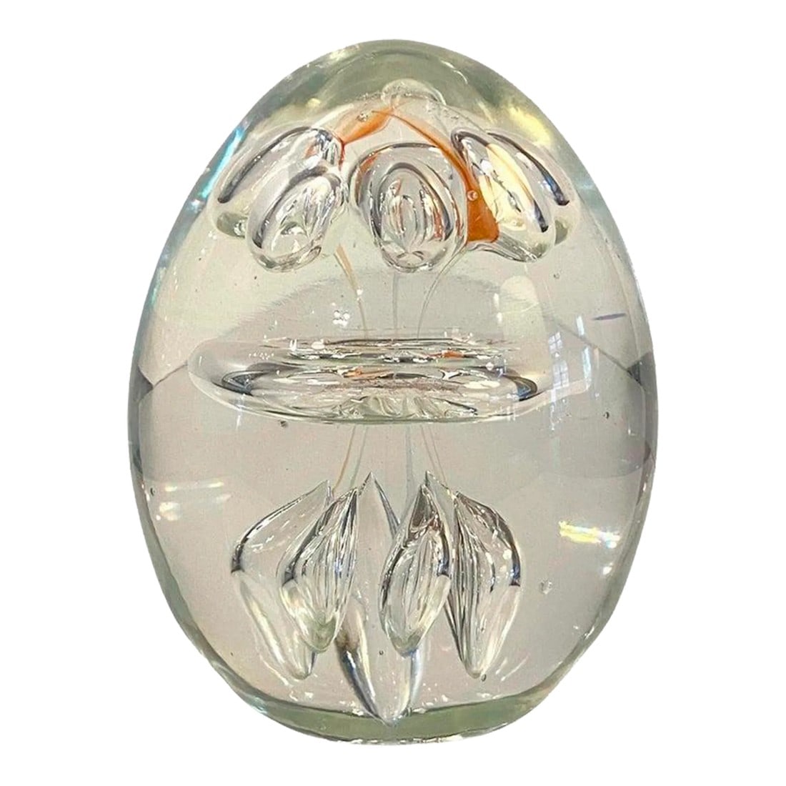 1980s Clear Hand Blown Art Glass Paperweight: Hand-blown, clear, oblong, art glass paperweight features a clear hand-blown center ring with several controlled bubbles atop and below with the faintest hints of orange dash around the top. Attribute