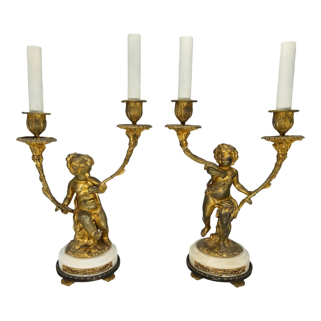 Pair, Gilt Bronze Louis XVI Style 19th Century Putti Candlestick Lamps: This superb pair of gilt bronze candlesticks, now electrified, embodies the elegance and charm of the Italian Renaissance, blended with elements of the Louis XVI style. The putti, representing the chi