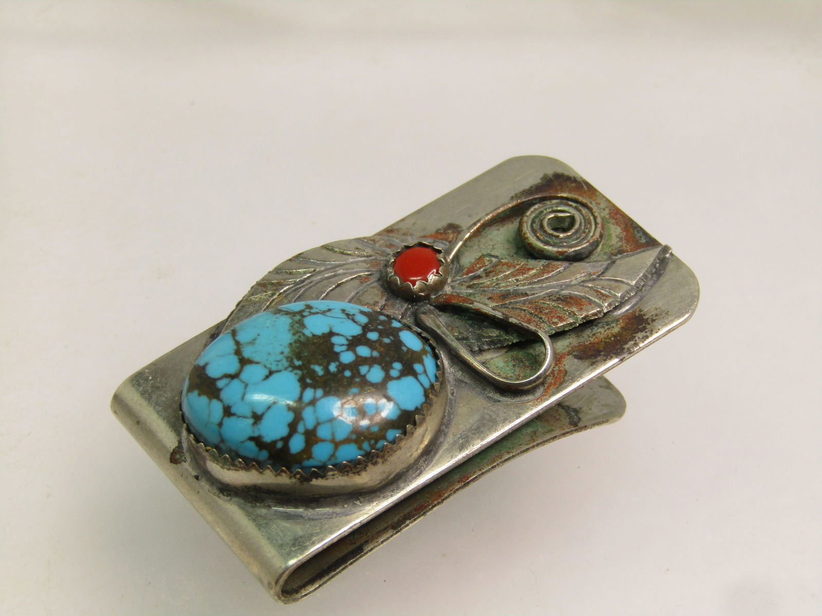 Vintage Southwestern Turquoise/Coral Money Clip, 1960's-1970's: Vintage Southwestern Turquoise/Coral Money Clip, 1960's-1970's. Silver tone plated lloy with some wear as can be seen in the photos. This has a large truquoise stone with black matrix. This is a large