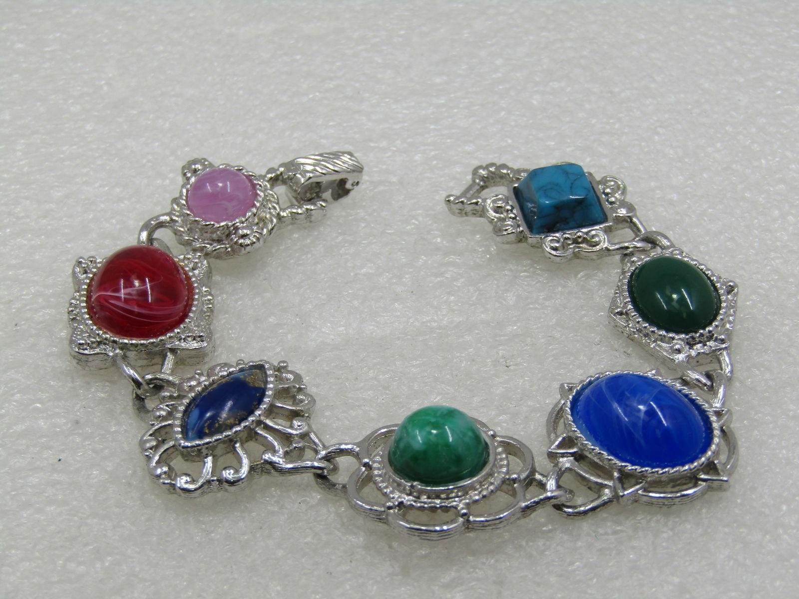 Vintage Southwestern Faux Agate Bracelet, Sarah Coventry, 7.5": Vintage Southwestern Faux Agate Bracelet, Sarah Coventry, 7.5". It is is appx. 1" wide at the widest point . A mix of faux stones: turquoise, malachite, lapis lazuli, sodalite, red agate, and others.