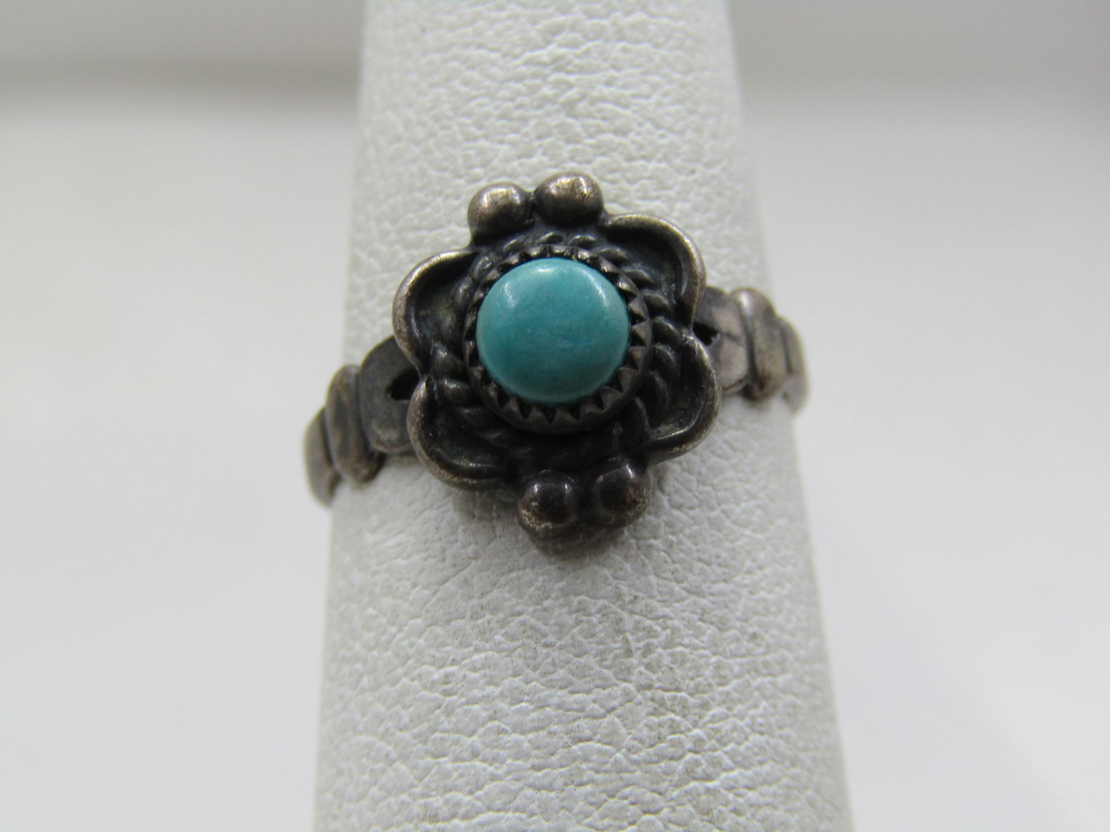 Vintage Sterling Southwestern Turquoise Ring, Sz. 4.5, Bell Trading Signed, 1960's: Vintage Southwestern turquoise ring, Sz. 4.5, Bell Trading Signed, 1960's. 5mm round turquoise stone that is sawtooth bezel-set and a squarish frame with two beads on the ends going down the finger. T