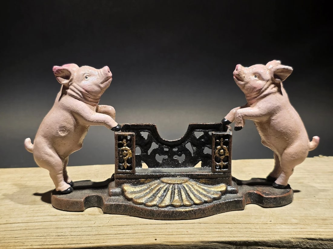 Cast Iron Country Pink Pig Cast Iron Business Card Holder: Title: Cast Iron Country Pink Pig Cast Iron Business Card Holder Description: Reproduction Country Pink Pig Cast Iron Business Card Holder. It features two pink pigs standing on their hind legs, suppo