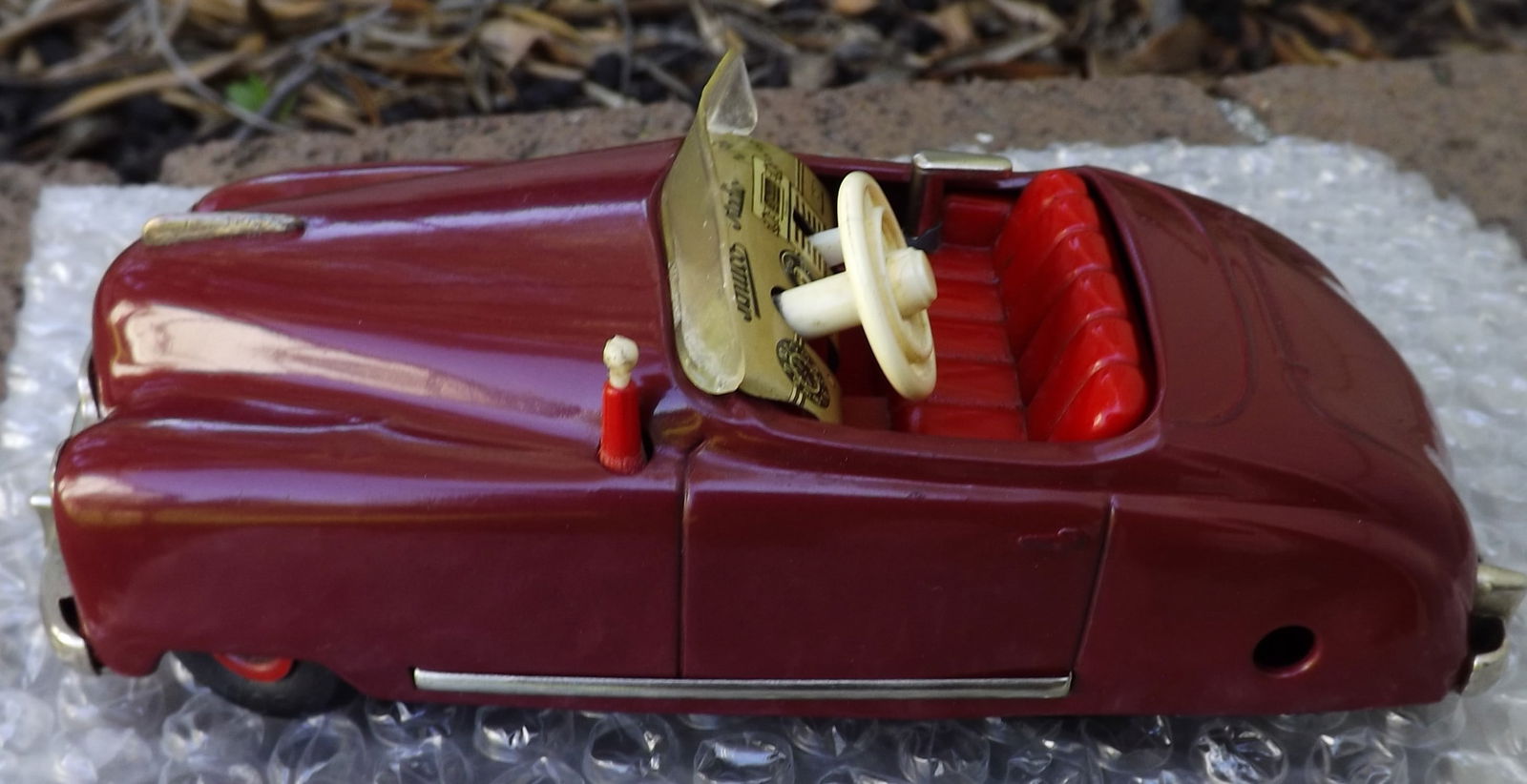 Schuco Radio 4012 (made in US Zone Germany,) two windup motors, one propels the car, the other one: Title: Schuco Radio 4012 (made in US Zone Germany,) two windup motors, one propels the car, the other one propels a music box (the "radio"), rack and pinion steering, functional handbrake, c9.5 . Desc