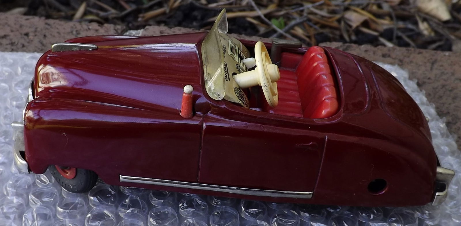 Schuco Radio 4012 (made in US Zone Germany,) two windup motors, one propels the car, the other one: Title: Schuco Radio 4012 (made in US Zone Germany,) two windup motors, one propels the car, the other one propels a music box (the "radio"), rack and pinion steering, functional handbrake, c9 . Descri