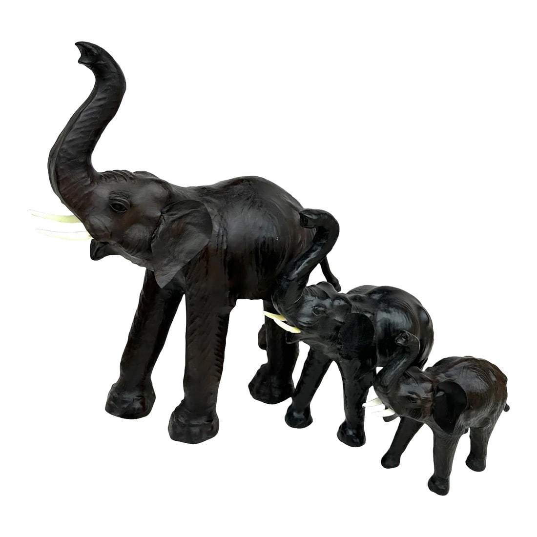 Large Antique Leather Wrapped Elephants-A Set: An Extraordinary Large leather wrapped work of art, this tusked elephant statue brings safari style to room decor. Three sizes all leather with faux tusk. Dark brown almost black looking. Perfect on a