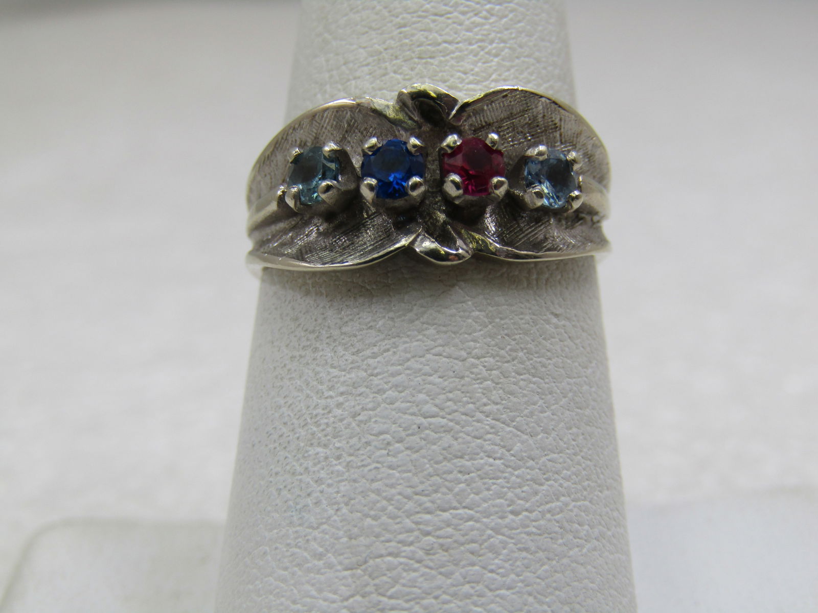 Vintage 14kt White Gold Mother's Ring, Sz. 7, 5: Title:Vintage 14kt White Gold Mother's Ring, Sz. 7, 5 Description:Vintage 14kt White Gold Mother's Ring, Sz. 7, 5. It has two ight blue topaz, a ruby, and a dark blue spinel sapphire. The birth months