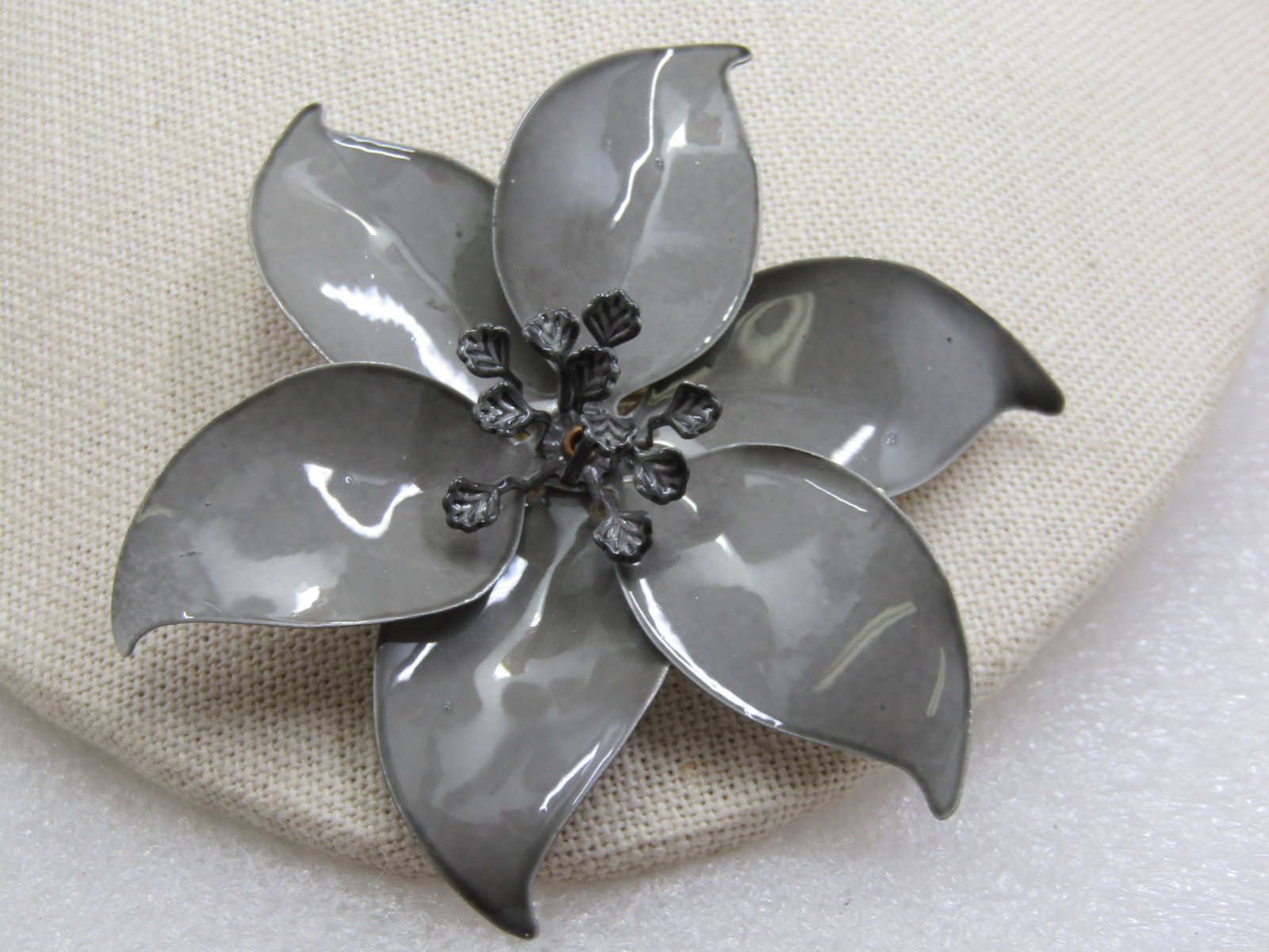 Vintage Enameled Gray Blossom Brooch, 1960's, 3.25": Vintage Enameled Gray Blossom Brooch, 1960's, 3.25". Large enameled pointed petal brooch, enameled in gray with darker gray anthers popping out of the center of the brooch. It has a white enameled bac