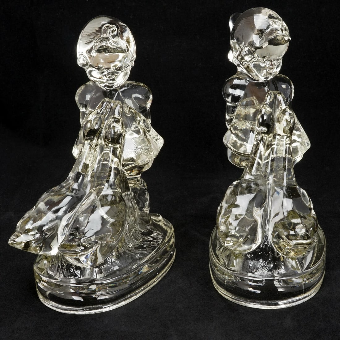 Up to Her Neck in Geese Glass Bookends: Title:Up to Her Neck in Geese Glass Bookends Size:7 ¼ in (18.4 cm) tall x 5 ¾ in (14.6 cm) long x 3 ½ in (8.9 cm) wide. Description:A molded pair of heavy glass bookends with a de