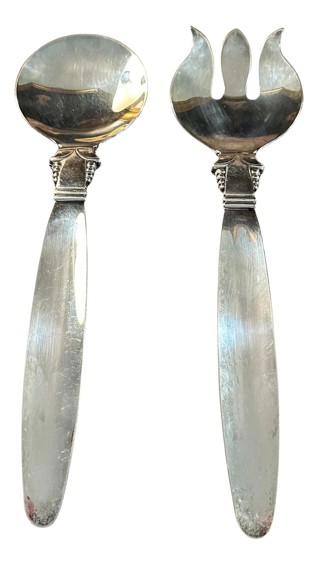 Mid 20th Century Jensen Style Serving Spoons- a Pair: A very impressive pair of Salad or Side Dish Servers in the style of George Jensen, the famous Danish Silver Smith. The serving pieces are large and practical for a Buffet Service. The detail on the h