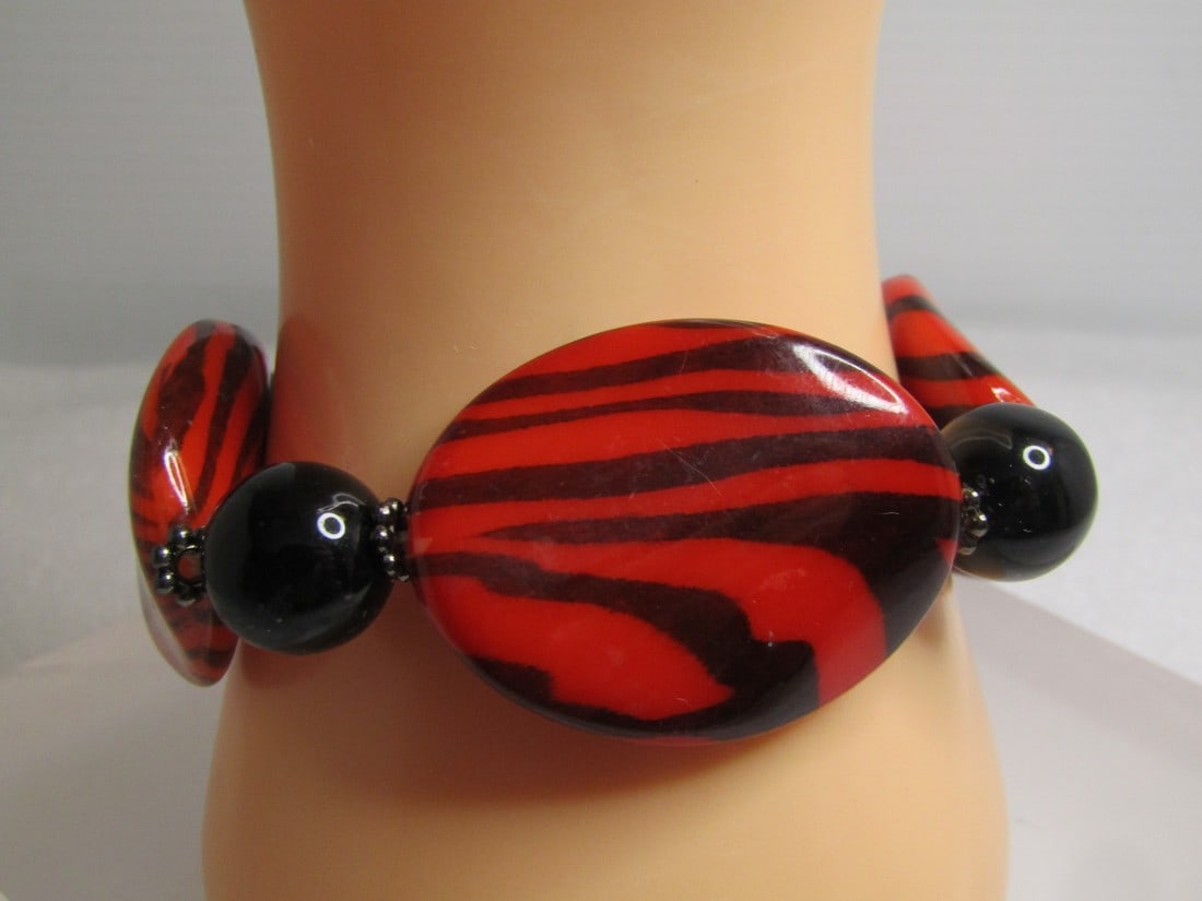 Red/Black Zebra Striped Chunky Bracelet, Stretch 7"+, 1980's: Title: Red/Black Zebra Striped Chunky Bracelet, Stretch 7"+, 1980's Description: Red/Black Zebra Striped Chunky Bracelet, Stretch 7"+, 1980's. These beads are a curved red lucite bead with black zebra