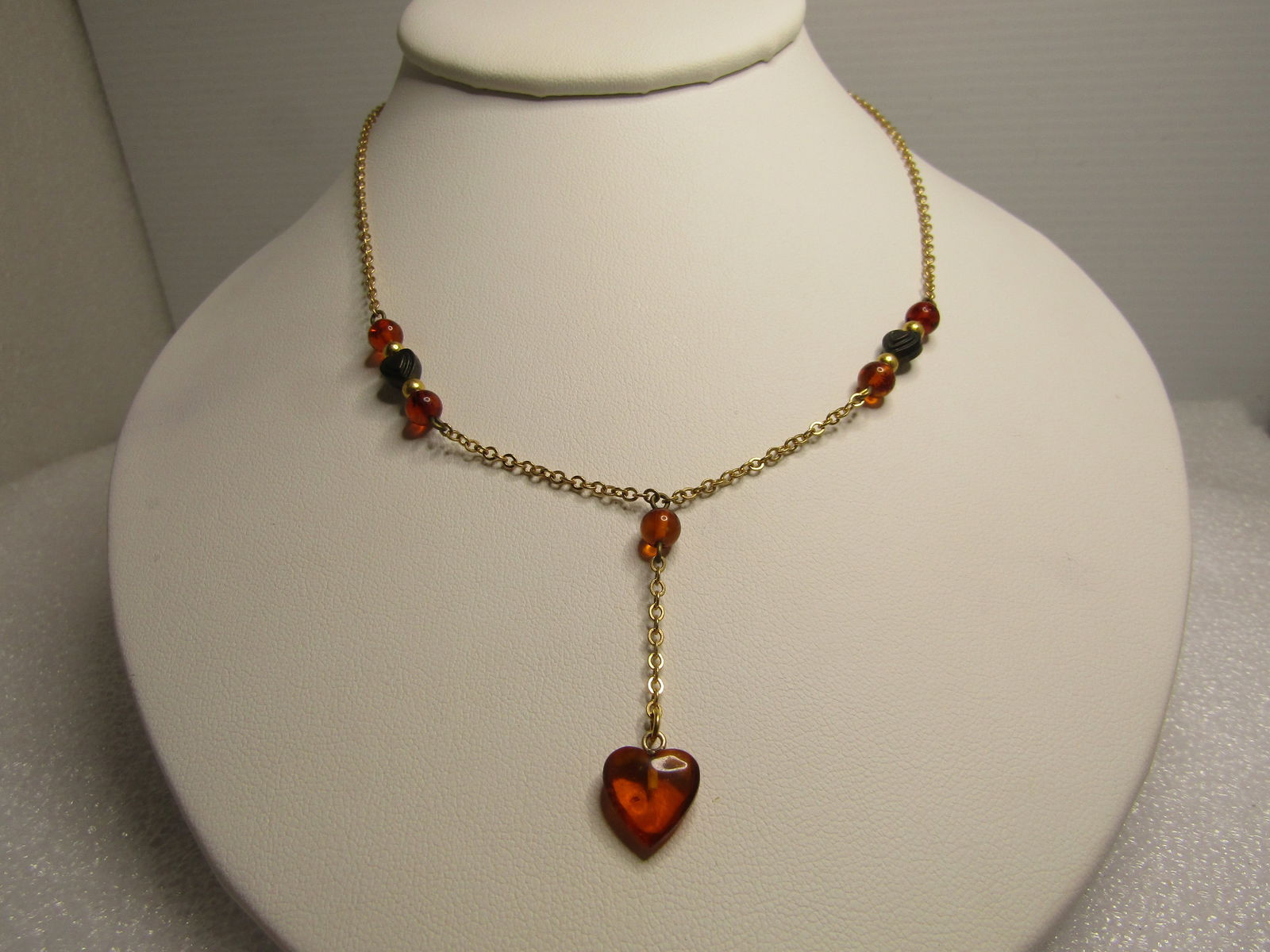 Vintage Amber Dangle Heart Necklace, 16" Lee Sands, 1980's: Title: Vintage Amber Dangle Heart Necklace, 16" Lee Sands, 1980's Description: Vintage Amber Dangle Heart Necklace, 16" Lee Sands, 1980's. Gold tone chain with a 1.5: drop with a 1/3" amber heart dang