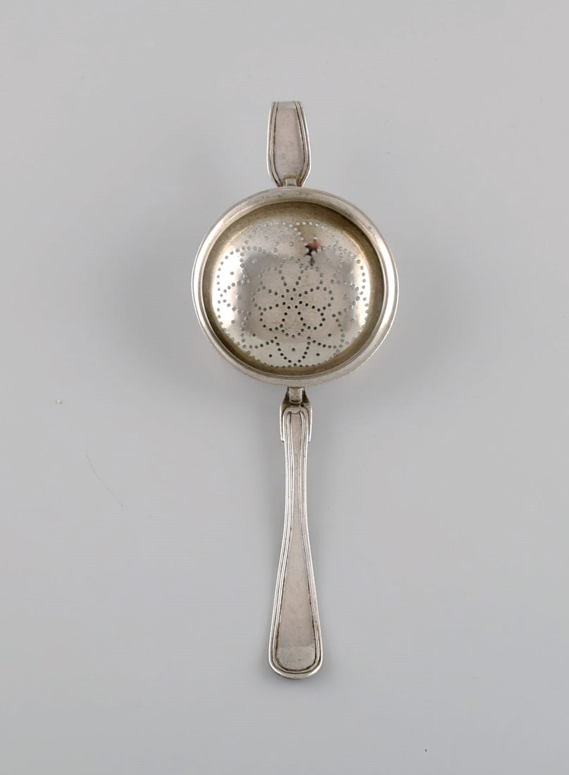 Danish silversmith. Antique silver (830) tea strainer. Dated 1874.: Title:Danish silversmith. Antique silver (830) tea strainer. Dated 1874. Description:Danish silversmith. Antique silver (830) tea strainer. Dated 1874. Length: 18 cm. In excellent condition. Stamped.