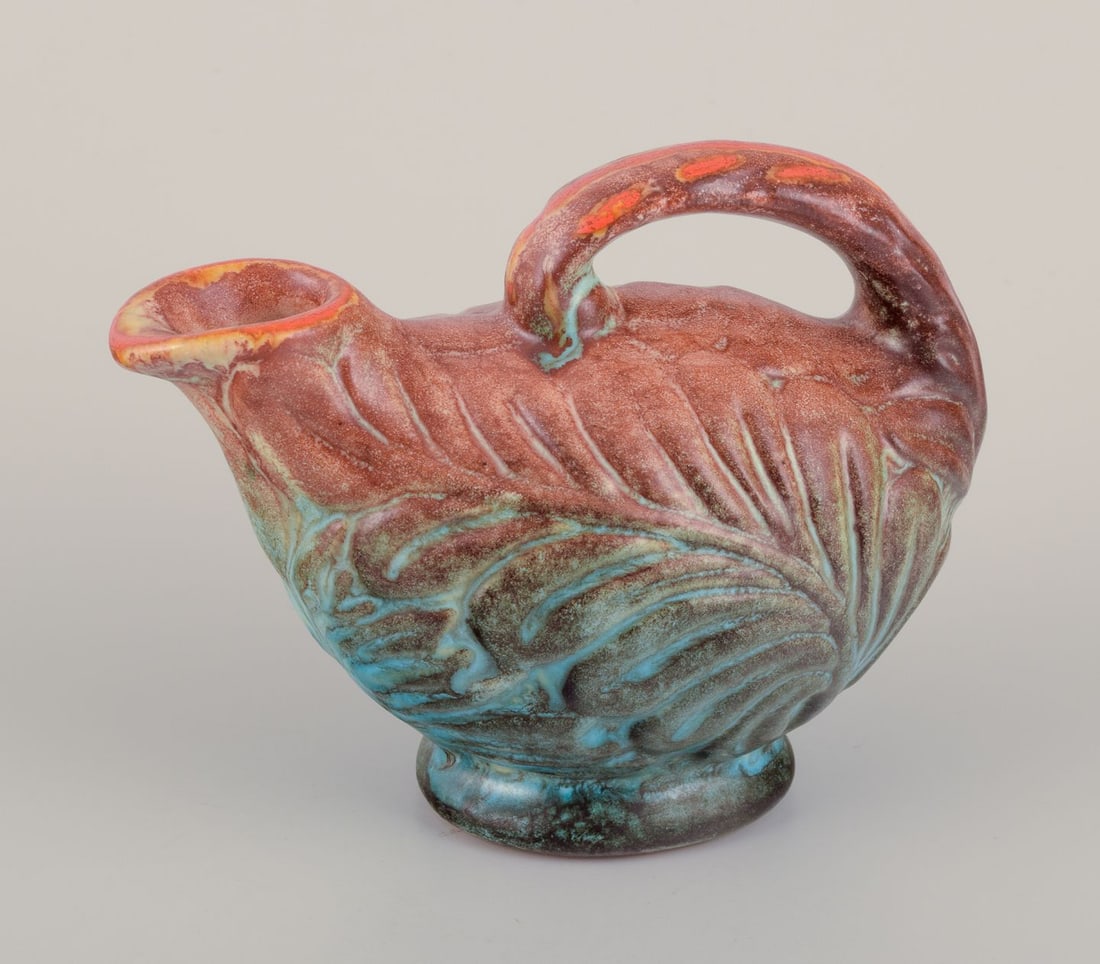 Michael Andersen, Bornholm. Small ceramic jug. Mid-20th C.: Michael Andersen (1859-1931), Bornholm. Small ceramic jug. Glaze in shades of brown, blue and green. Model 5147. Mid-20th c. Marked. Perfect condition. Dimensions: L 13.0 cm. x Height 10.0 cm. Reserve