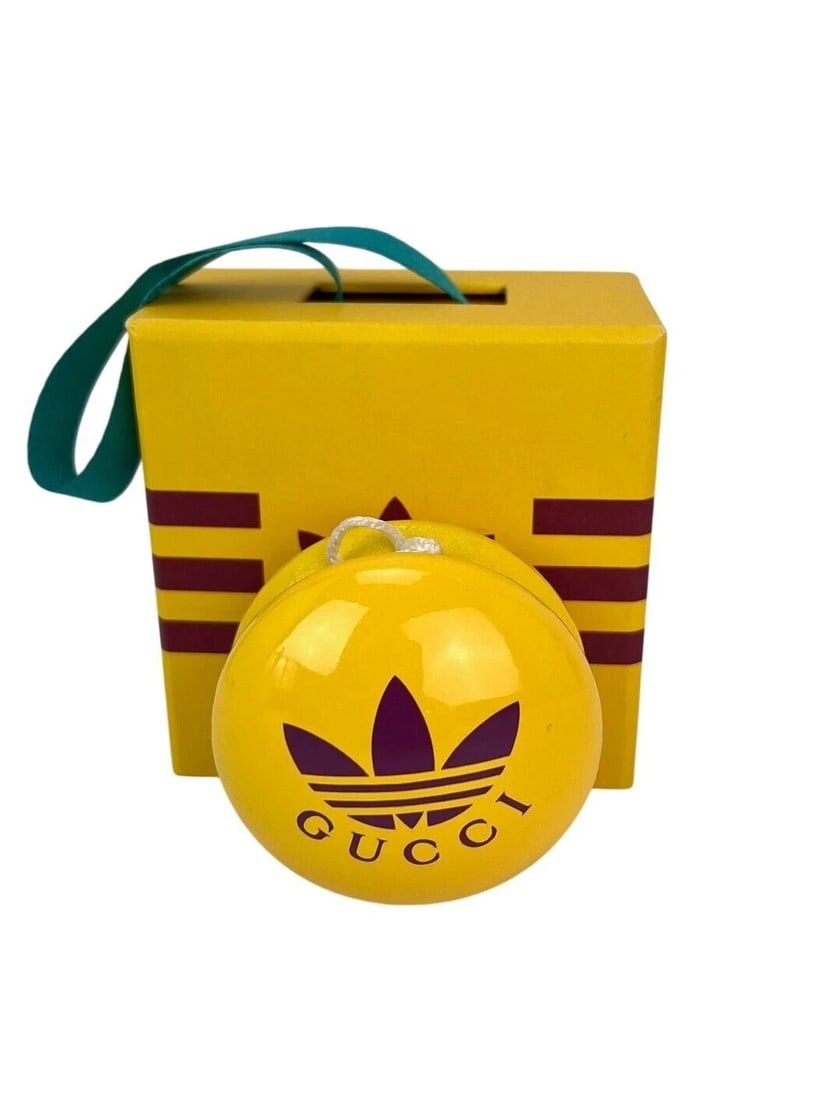 Gucci x Adidas Yellow Wood Yoyo: Title: Gucci x Adidas Yellow Wood Yoyo Additional Information: Pre-Owned 100% Authentic Gucci x Adidas Yellow Wood Yoyo RATING: A...excellent, near mint, has little to no signs of wear MATERIAL: woode