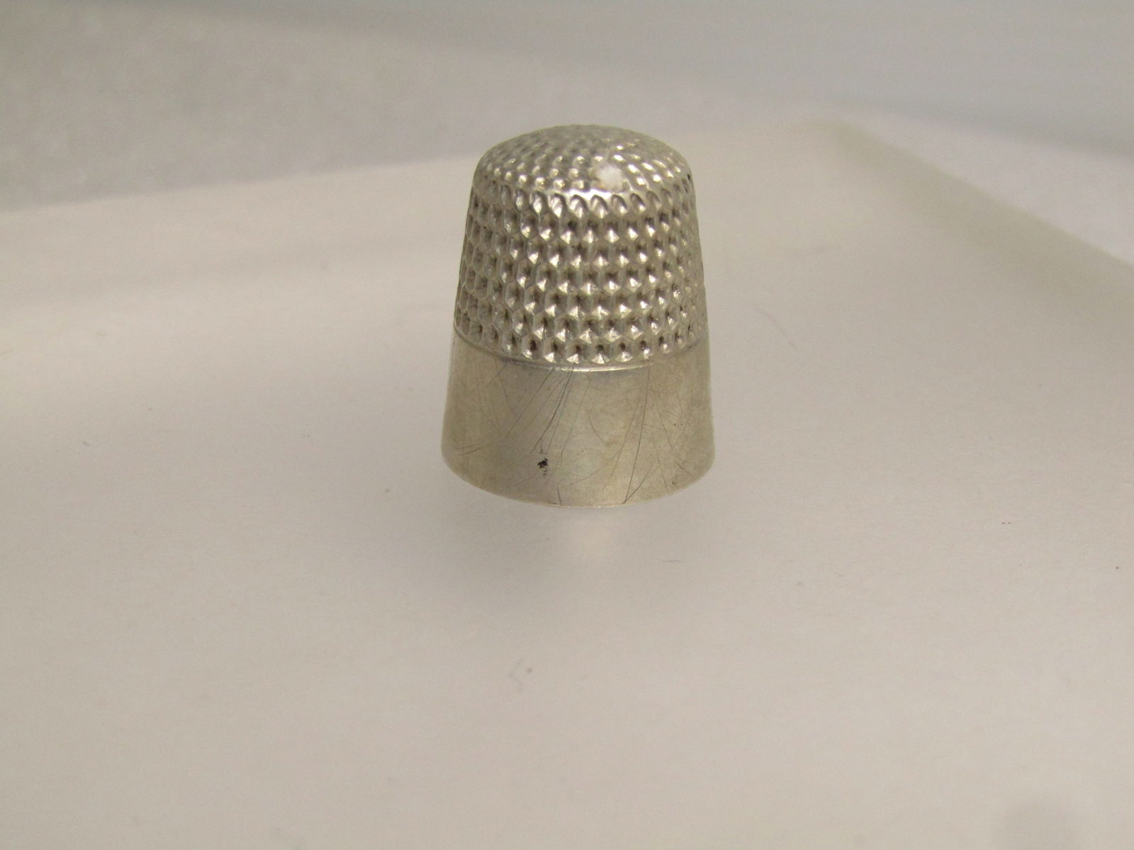 Vintage to Antique Sterling Thimble, Sz. 7, Signed , 1920's-1940's: Vintage to Antique Sterling Thimble, Sz. 7, Signed , 1920's-1940's, possilby older. It is marked sterling on the inside of the top of the thimble and signed with a W and what looks like a C and Co off