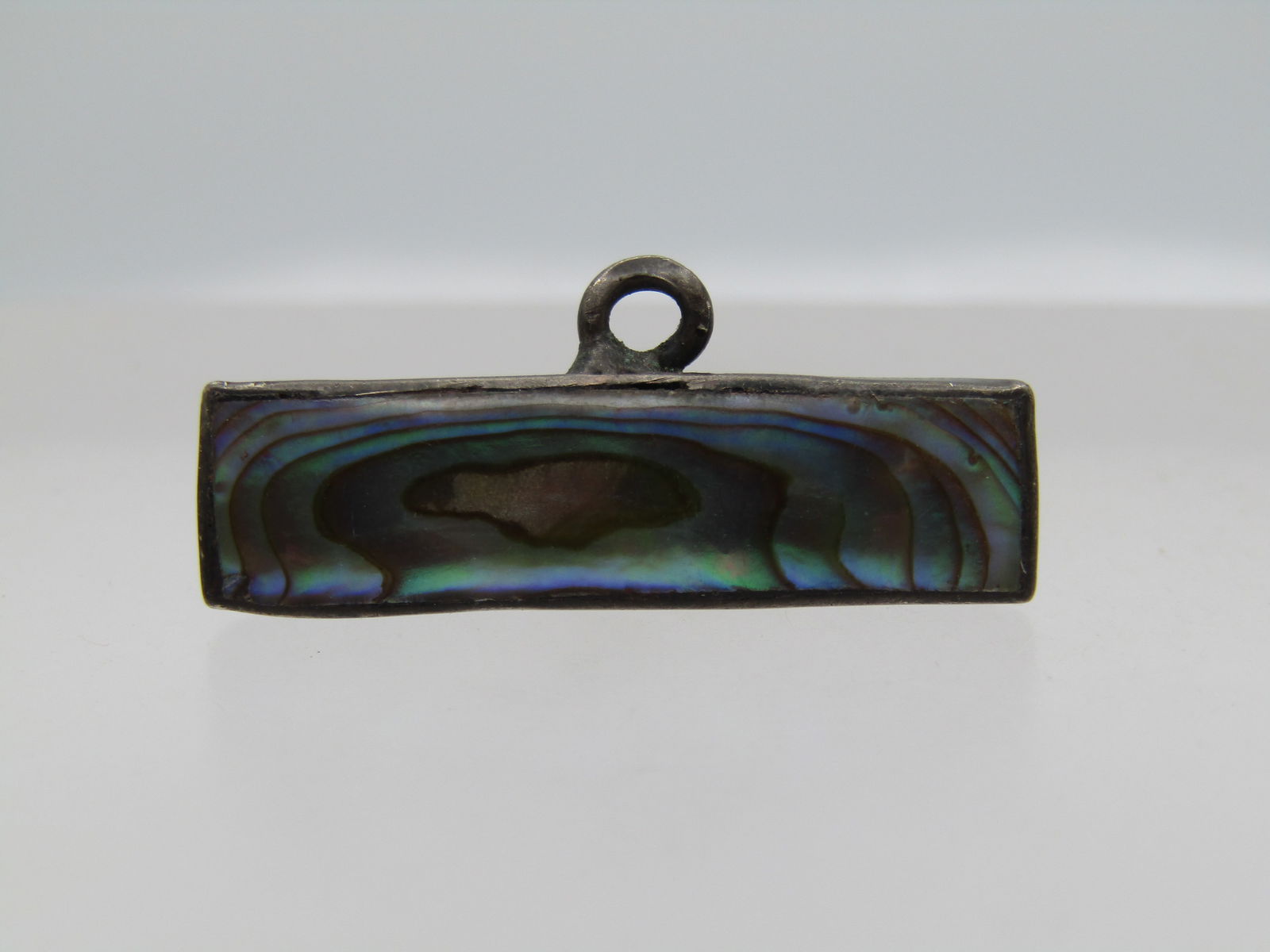 Vintage Sterling Abalone Bar Brooch with Loop, 1920's-1930's: Vintage Sterling Abalone Bar Brooch with Loop, 1920's-1930's. It is appx. 1-1/8" long and slightly over 1/4" tall. It has a single O ring mounted on the bottom to add something to the brooch. It tests