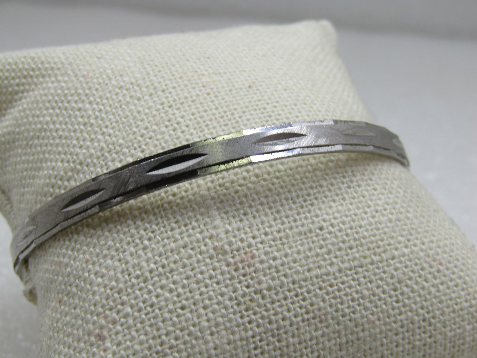 Vintage Sterling Diamond Cut Bangle Bracelet, 7.75", Signed Wells: Vintage Sterling Diamond Cut Bangle Bracelet, 7.75", Signed Wells, 4.5mm wide. Notched diamond cut design with smoth and satin finish. 10.40 gr. Marked sterling and tested. Very good condition. 1960's
