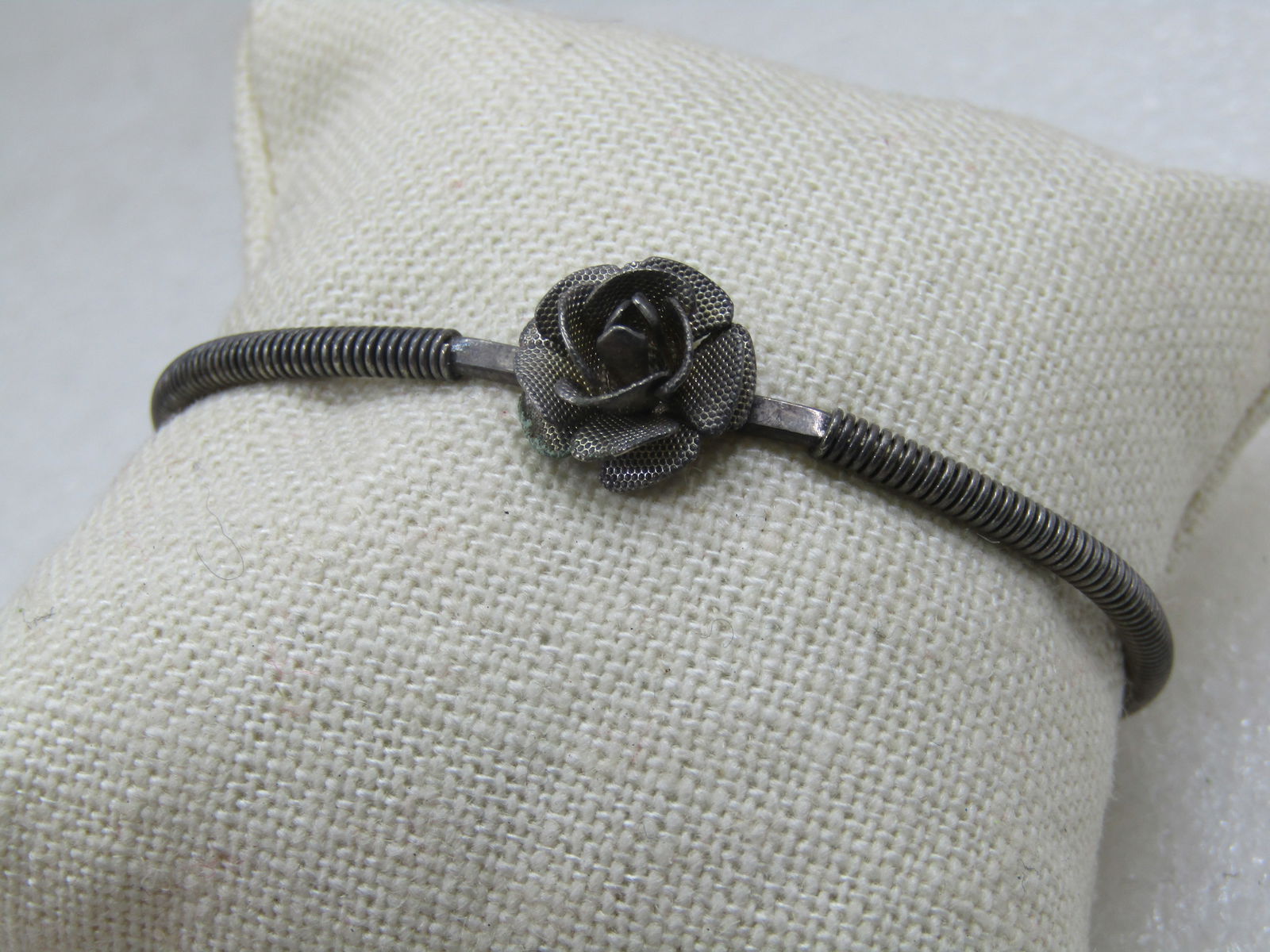 Vintage Silver Tone Rose Blossom Cuff Bracelet 6": Vintage Silver Tone Rose Blossom Cuff Bracelet 6. This is 6" icnluding the opening in the back of the cuff. Thre is a 3-D rose blossom with textured finish on top of the wrist that is appx. 1/2". The