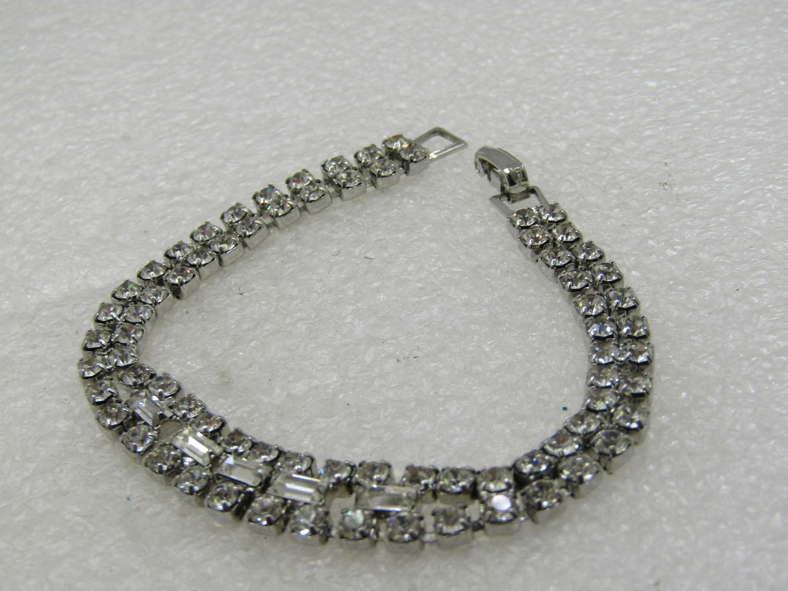 Vintage Rhinestone Double Strand Bracelet with Baguettes, 7.25": Vintage Rhinestone Double Strand Bracelet with Baguettes, 7.25". SIlver tone. It is 6.5mm wide on the sides of center and appx. 8mm in the center with five baguettes separating the two strands. Silver
