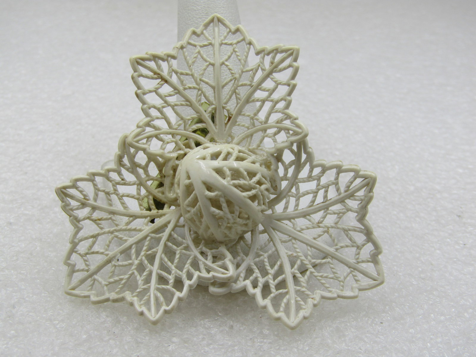 Vintage White Filigree Leaf Brooch, Domed Center, 2.5": Vintage White Filigree Leaf Brooch, Domed Center, 2.5". Three white plastic filigree leaves with a center 3/4" half-circled domed center which is also filigree. Age is appx. 1930s. It is not signed by