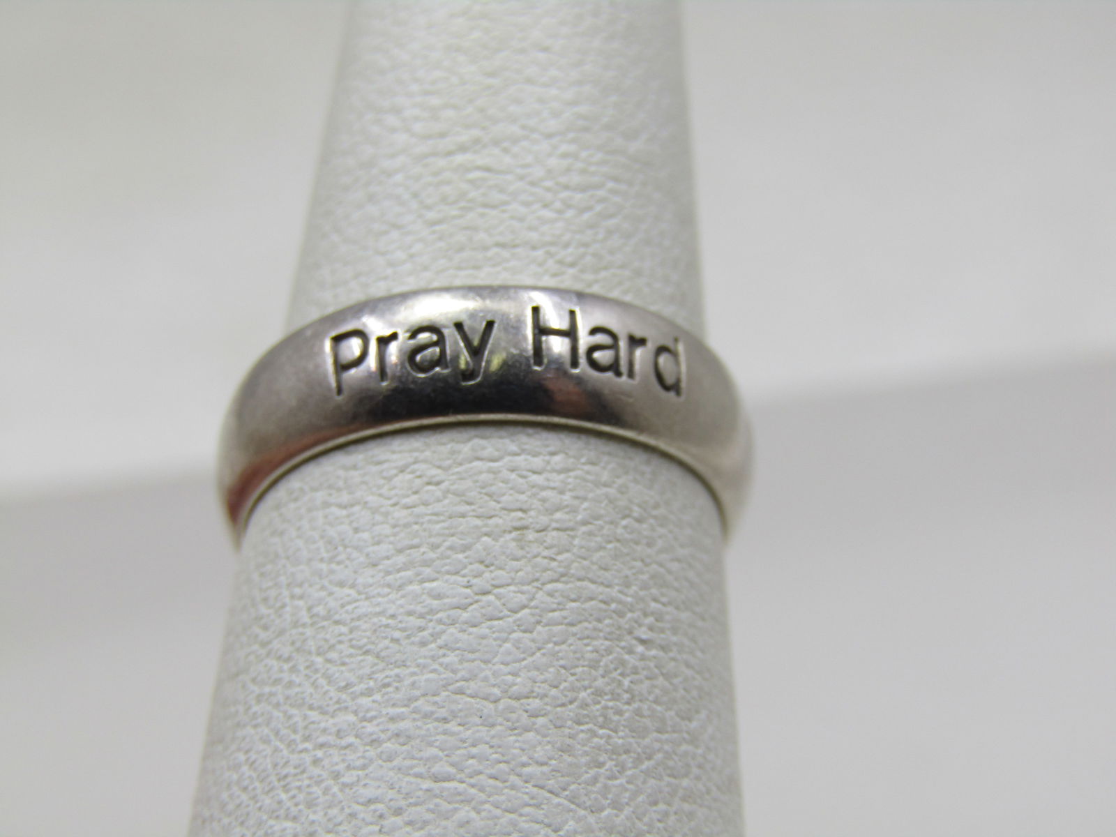 Vintage Sterling Pray Hard Ring, Wedding Band, Sz. 7: Vintage Sterling Pray Hard Ring, Wedding Band, Sz. 7. It is 5mm wide with Pray Hard engraved in the band in one place that would sit on top of the finger. It is marked sterling and signed either RSD o