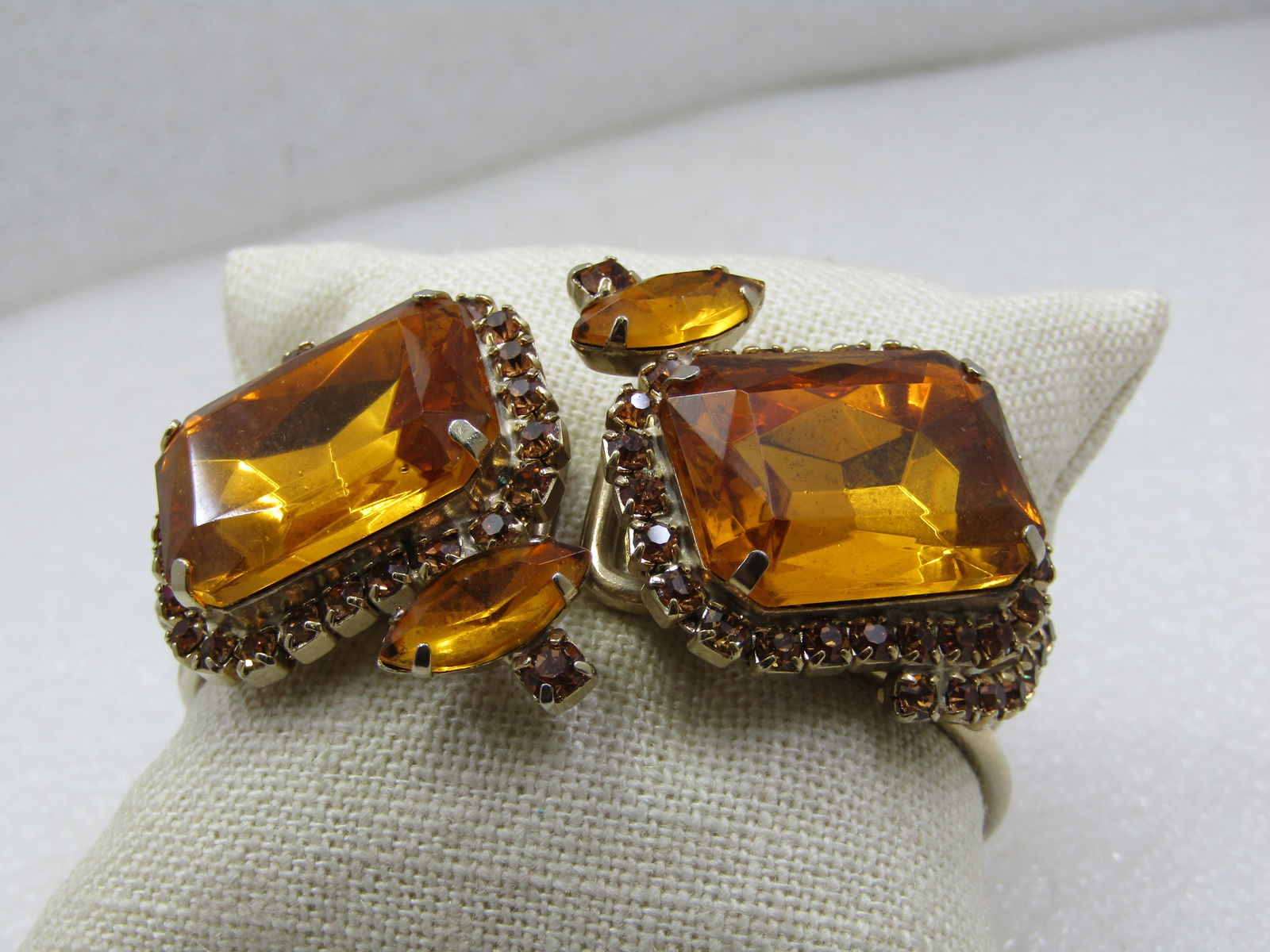 Vintage Golden Rhinestone Hinged Clamper Bracelet, 1960's-1970's, 6"-7": Vintage Golden Rhinestone Hinged Clamper Bracelet, 1960's-1970's, 6"-7". Statement bracelet. Gold tone double band bracelet with hinge at the back and on top one each side1" by 3/4" bezel-set and pron