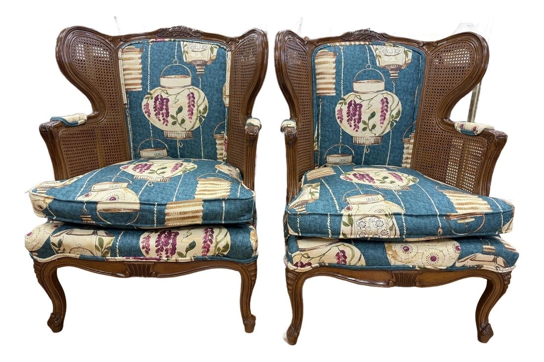 Pair of Vintage Cane Wingback Chairs With New Chinoiserie Upholstery: A charming pair of small scale wingback chairs, recently revitalized with new upholstery in a delightful blue chinoiserie fabric and the front and coordinating floral upholstery on the back. The intri
