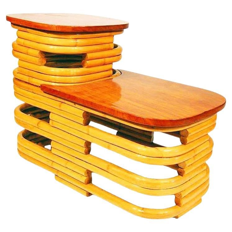 Restored MCM Stacked Rattan Two-Tier Side Table w/ Mahogany Top, 2 Available: Title: Restored MCM Stacked Rattan Two-Tier Side Table w/ Mahogany Top, 2 Available Description: Beautifully restored 1940s two-tier stacked rattan side table with stylized cut-out sides and beautiful