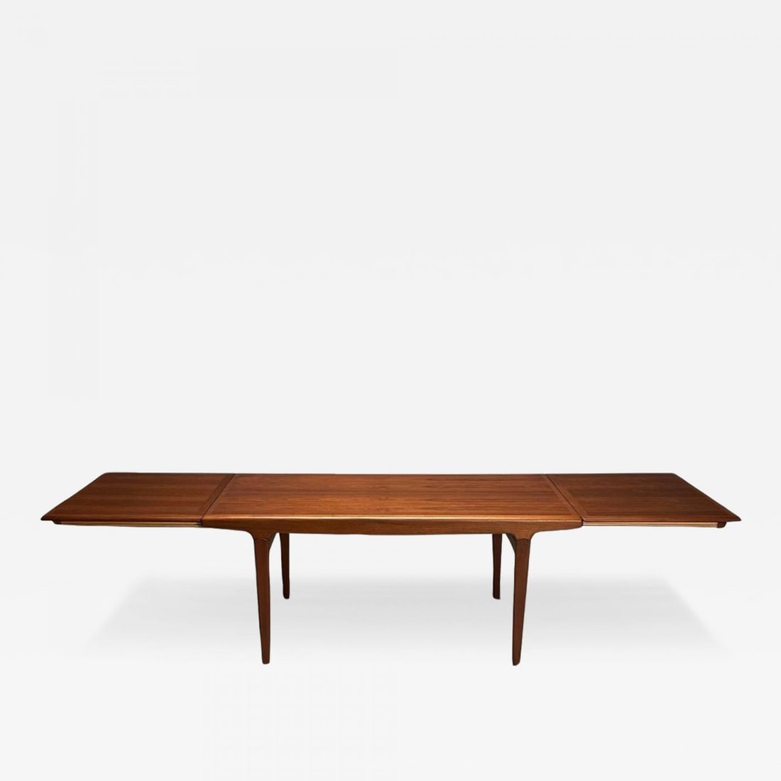 Johannes Andersen, Danish Mid-Century Modern, Dining Table, Teak, Denmark, 1960s: Title: Johannes Andersen, Danish Mid-Century Modern, Dining Table, Teak, Denmark, 1960s Description: Johannes Andersen, Danish Mid-Century Modern, Hidden Leaf Dining Table, Teak, Denmark, 1960s A full