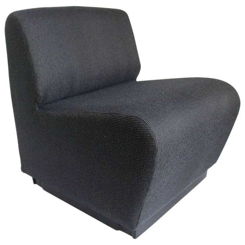 French 1970s Slipper Chair in Charcoal Gray: Title: French 1970s Slipper Chair in Charcoal Gray Description: A comfy, minimal French 1970s slipper chair. It sits on a modern, black platform and is upholstered in charcoal gray fabric. REFERENCE N