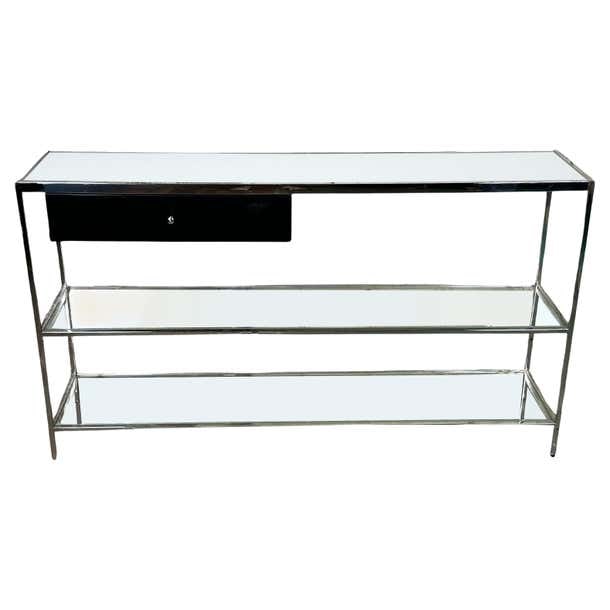 Glass and Chrome Console Table in Milo Baughman's Style: Title: Glass and Chrome Console Table in Milo Baughman's Style Description: This console, inspired by the designs of Milo Baughman, features a sleek aesthetic that blends modern materials and classic