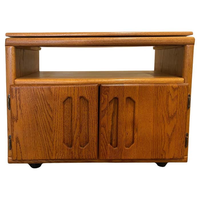 Midcentury Rolling TV Cabinet in Walnut: Title: Midcentury Rolling TV Cabinet in Walnut Description: This mid-century rolling TV cabinet is made of walnut. It features a top section that pivots, allowing the television to be oriented in any
