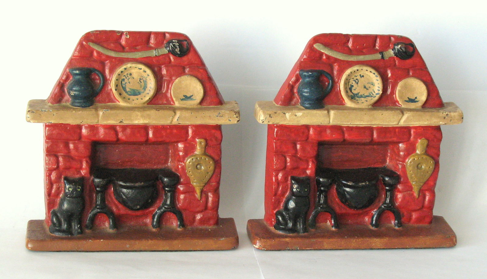 Antique cast iron fireplace bookends original paint.: Title: Antique cast iron fireplace bookends original paint. Date/Period: 1930's Dimension: 5 1/2” x 5 3/4” Additional Information: Nice pair of antique cast iron fireplace bookends in grea